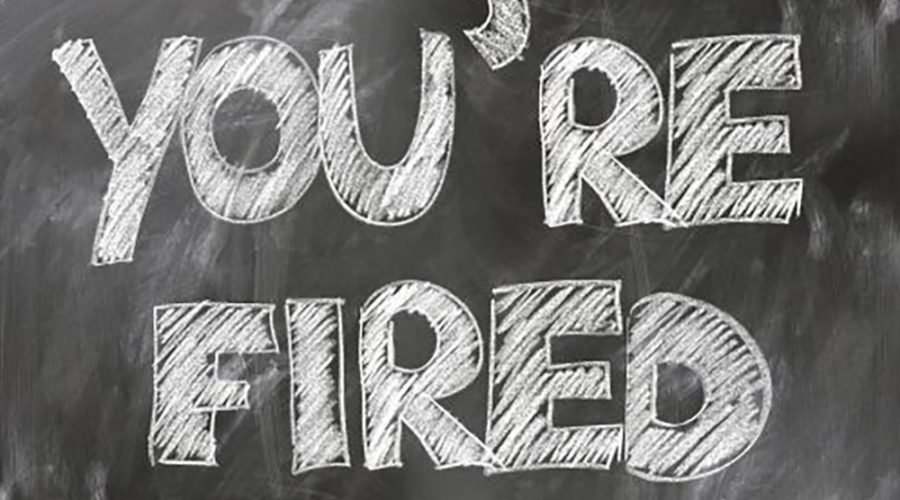 An image of a chalkboard with the words You're Fired written on it.
