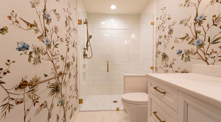 Elegant bathroom with botanical wallpaper and glass shower